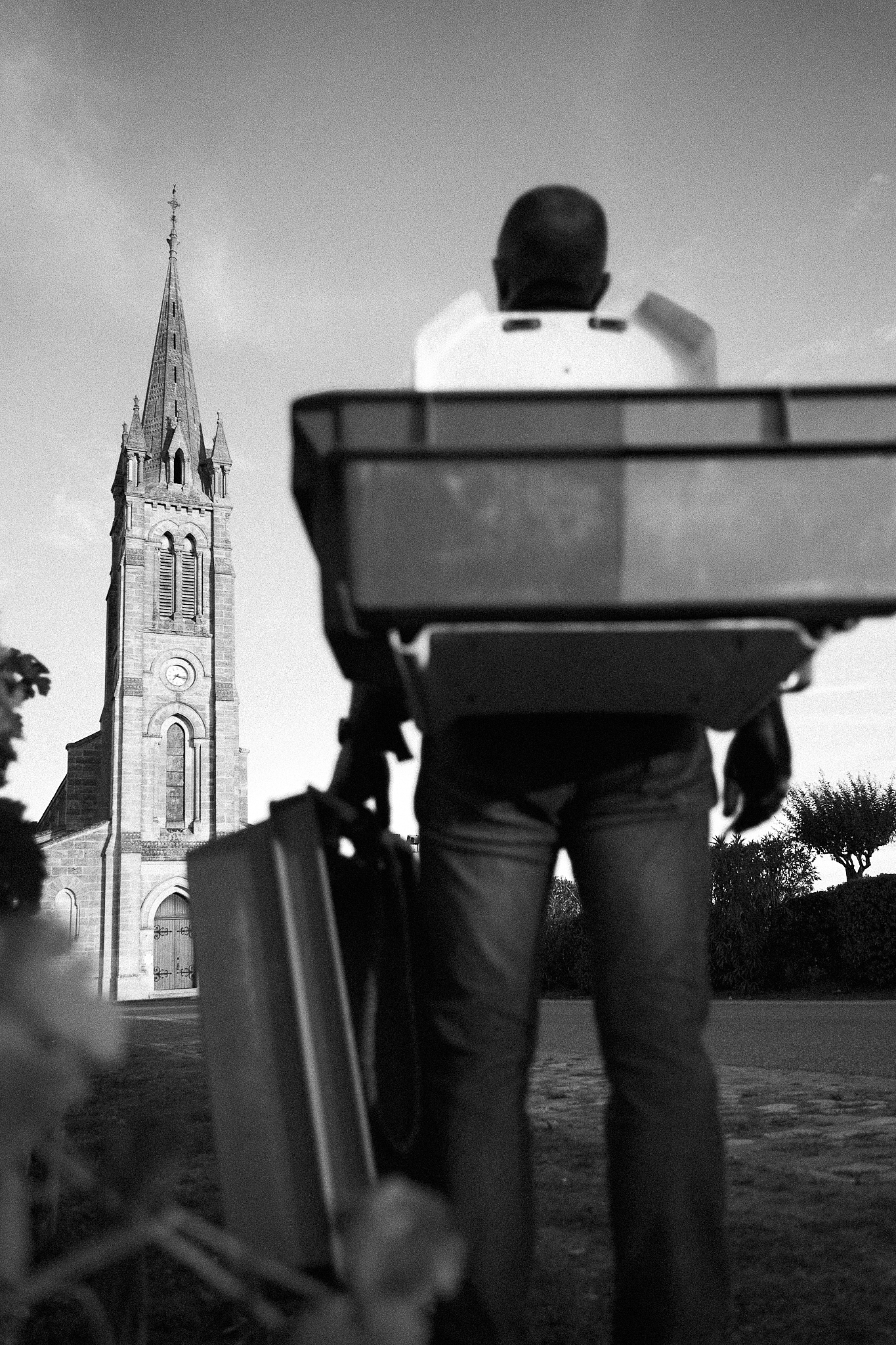 Harvest seen from behind gazing up at Pomerol church.